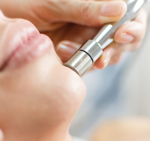 Diamond microdermabrasion, peeling cosmetic. woman during a microdermabrasion treatment in beauty salon